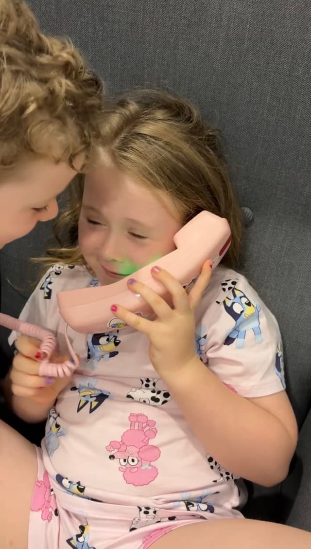 Two kids talking on Yarnie phones