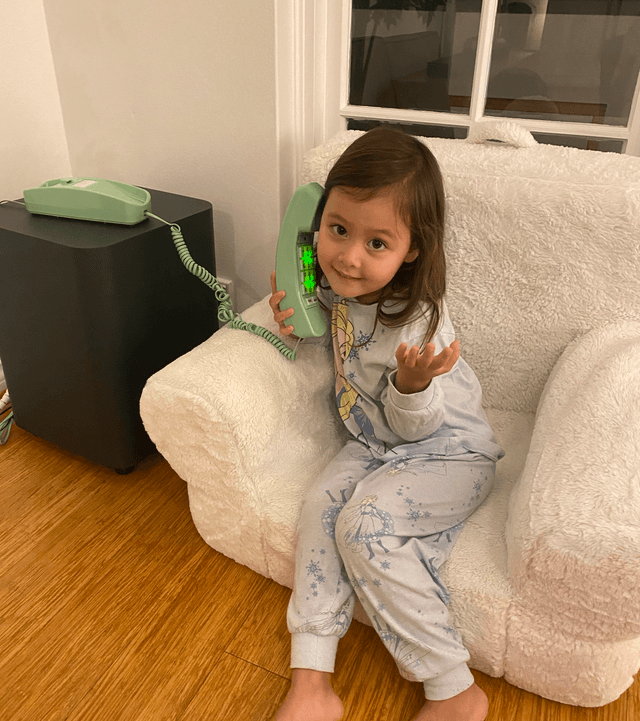 Ari talking on a Yarnie phone