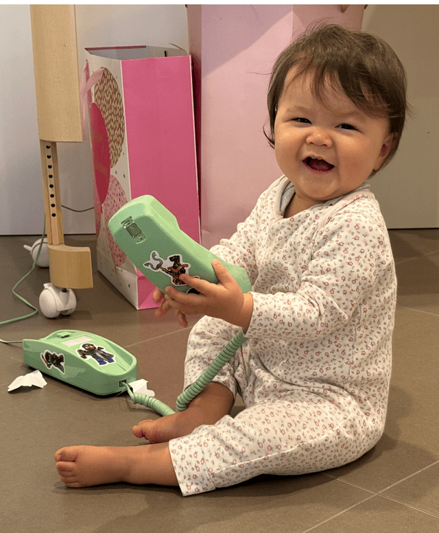 Two kids talking on Yarnie phones